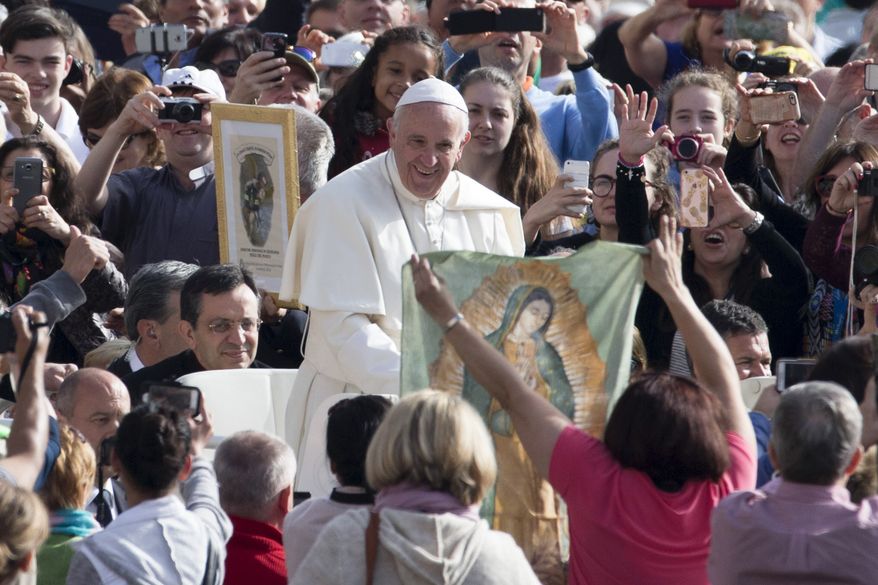Faithful and tourists call out to Pope Francis as he arrives for his weekly general audience, in St. Peter's Square at the Vatican, Wednesday, April 6, 2016. (AP Photo/Andrew Medichini)
