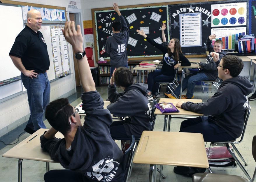 ADVANCE FOR USE SATURDAY, APRIL 9 AND THEREAFTER - In this March 4, 2016 photo, Jeff Grove, the mayor of La Salle, Ill., fields questions from eighth-grade American history students at Trinity Catholic School in La Salle. Grove explained La Salle government to the 16 students in the class. (Chris Yucus/NewsTribune via AP) MANDATORY CREDIT