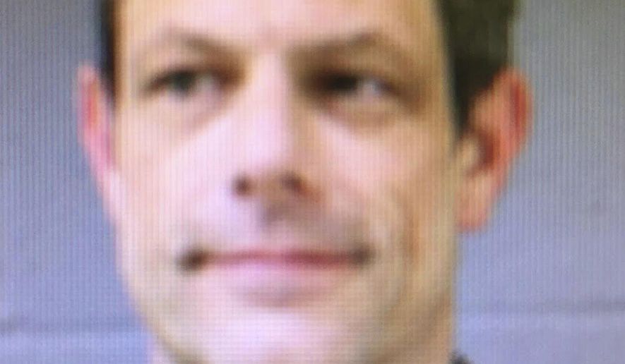 This booking photo released by the Newtown Police Department shows Jason Adams, arrested Wednesday, April 6, 2016, and charged with having a gun at the town's middle school. Adams, 46, a teacher at the school, was charged with possession of a weapon on school grounds, which is illegal in Connecticut. Police said he has a valid pistol permit. A gunman shot and killed 20 students and six educators at nearby Sandy Hook Elementary School in Newtown in December 2012. (Newtown Police Department via AP)