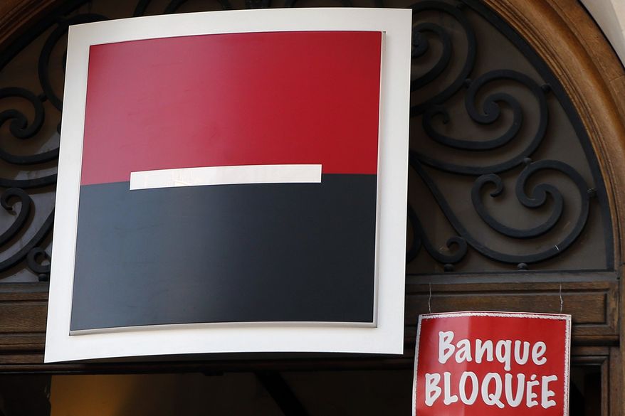 A label reading " Bank Blocked" is sticked by anti-fraud activists next the logo of Societe Generale as part of a protest accusing the French bank of ties to the so-called "Panama Papers" in Paris, France, Thusday, April 7, 2016. Societe Generale denies any accusations of fraud and tax evasion and repeated in a statement its commitment to the fight against such activities. (AP Photo/Francois Mori)