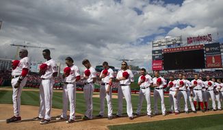 The Washington Nationals line up for the national anthem before their first home game against the Miami Marlins, at Nationals Park, on Thursday. (AP Photo/Evan Vucci)