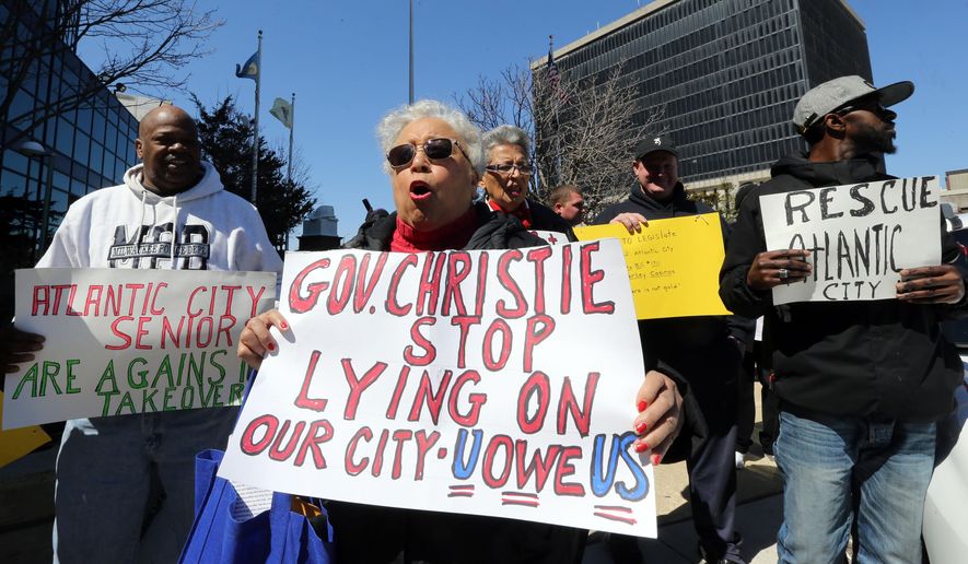 Alma Johnson of Atlantic City, leads a rally of citizens and city workers gathered outside city hall to voice their opinions on the city takeover, Wednesday, April 6, 2016. Gov. Chris Christie held a news conference at the Atlantic County Offices in Atlantic City to discuss the city's financial problems. (Dale Gerhard/Press of Atlantic City via AP)