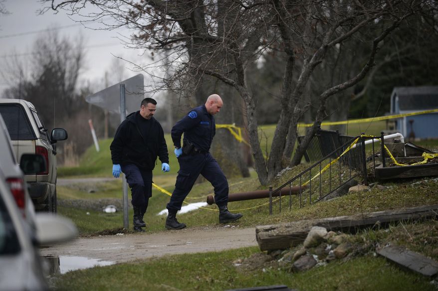 In this Wednesday, April 6, 2016 photo, Michigan State Police walk up to a house to investigate after a body was found inside in Forest Township, Mich. Police say a man has been found dead after an explosion while he was mixing chemicals inside a rural Genesee County home. (Rachel Woolf/The Flint Journal-MLive.com via AP) LOCAL TELEVISION OUT; LOCAL INTERNET OUT; MANDATORY CREDIT
