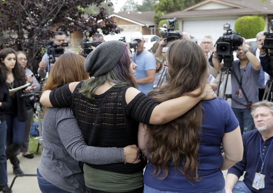 Family and friends of Gabriel Fernandez, an 8-year-old boy who died in 2013, face reporters at a news conference in the Sylmar district of Los Angeles, Thursday, April 7, 2016. Prosecutors charged four Los Angeles County social workers with child abuse, saying they were so negligent in handling the case of the young boy who died of gruesome, multiple injuries that, just like his abusers, they were criminally responsible. Gabriel's mother, Pearl Fernandez, and her boyfriend, Isauro Aguirre, have pleaded not guilty to murder and are in jail awaiting trial. (AP Photo/Nick Ut)