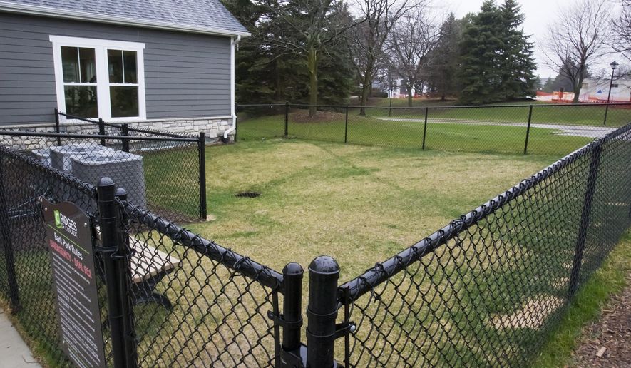 This Wednesday, April 6, 2016, shows the dog park at Ridges of Cascade in Grand Rapids, Mich. The high-end apartment community near Grand Rapids plans to use DNA technology as a way to sniff out dog owners who fail to pick up their pets' feces. The Ridges of Cascade complex in Cascade Township is asking dog owners to swab their pet's mouth so it can build a DNA database that will allow it to identify residents who ignore its strict cleanup policy. (Cory Morse /The Grand Rapids Press via AP) ALL LOCAL TELEVISION OUT; LOCAL TELEVISION INTERNET OUT; MANDATORY CREDIT