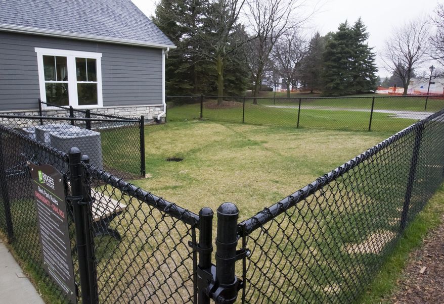 This Wednesday, April 6, 2016, shows the dog park at Ridges of Cascade in Grand Rapids, Mich. The high-end apartment community near Grand Rapids plans to use DNA technology as a way to sniff out dog owners who fail to pick up their pets' feces. The Ridges of Cascade complex in Cascade Township is asking dog owners to swab their pet's mouth so it can build a DNA database that will allow it to identify residents who ignore its strict cleanup policy. (Cory Morse /The Grand Rapids Press via AP) ALL LOCAL TELEVISION OUT; LOCAL TELEVISION INTERNET OUT; MANDATORY CREDIT