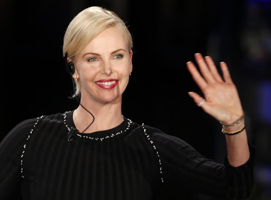 FILE - In this March 31, 2016 file photo, actress Charlize Theron waves as she attends the Italian State RAI TV program "Che Tempo che Fa", in Milan, Italy. (AP Photo/Antonio Calanni)