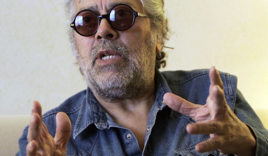 FILE - In this Aug. 7, 2008 file photo Argentine folk singer Facundo Cabral speaks during an interview with The Associated Press in Miami. A court in Guatemala has found 5 men guilty on Thursday, April 7, 2016, of the 2011 shooting death of Cabral. (AP Photo/Alan Diaz, File)