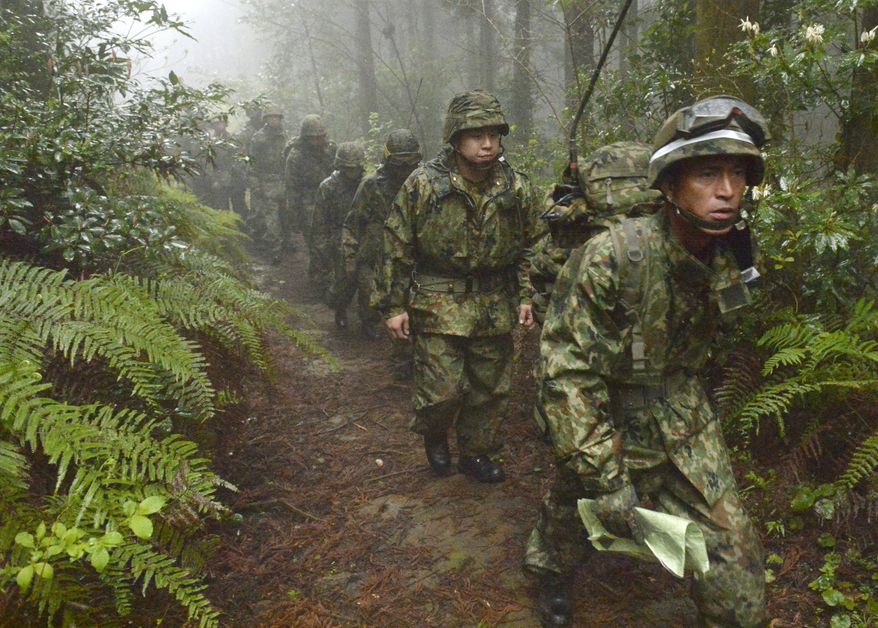 Members of the Japan Self-Defense Forces resume a search operation for a disapeared Japanese military jet carrying six airmen, in Kanoya city, Kagoshima prefecture, southern Japan, Thursday, April 7, 2016. The military jet carrying six airmen disappeared from radar over southern Japan on Wednesday afternoon, and the search has been suspended for the night. The plane disappeared about an hour after takeoff from Kanoya base for what was supposed to be a three-hour flight, the Defense Ministry said. (Sadayuki Goto/Kyodo News via AP) JAPAN OUT, CREDIT MANDATORY