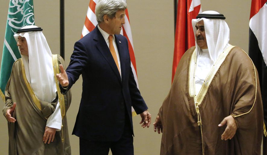 Secretary of State John Kerry talks with Bahrain Foreign Minister Khalid bin Ahmed Al Khalifa, right, after they and Saudi Arabia Foreign Minister Adel al-Jubeir, left, gathered for a family photo at the start of the Gulf Cooperation Council (GCC) Ministerial meetings in Manama, Bahrain, Thursday, April 7, 2016. (Jonathan Ernst/Pool Photo via AP)