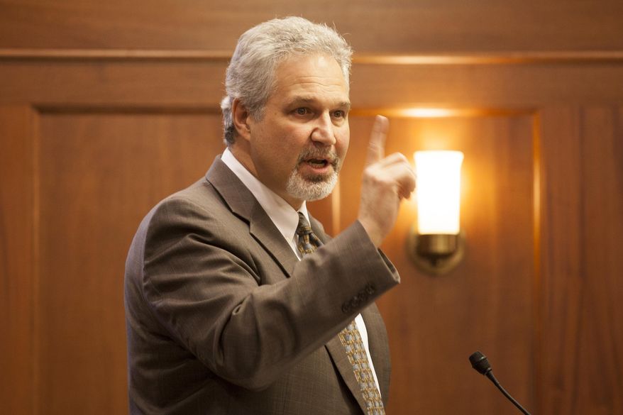 Sen. Pete Kelly, R-Fairbanks, talks about his bill to allow concealed weapons on University of Alaska campuses on Thursday, April 7, 2016, in Juneau, Alaska. The bill passed through the Senate and will now be taken up by the state House. (AP Photo/Rashah McChesney)