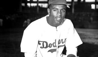 FILE - In this April 11, 1947 file photo, Jackie Robinson of the Brooklyn Dodgers poses at Ebbets Field in the Brooklyn borough of New York. Robinson is the subject of a two-part documentary, &quot;Jackie Robinson&quot; directed by Ken Burns, Sarah Burns and David McMahon airing Monday and Tuesday at 9 p.m. on most PBS stations.   (AP Photo/John Rooney, File)