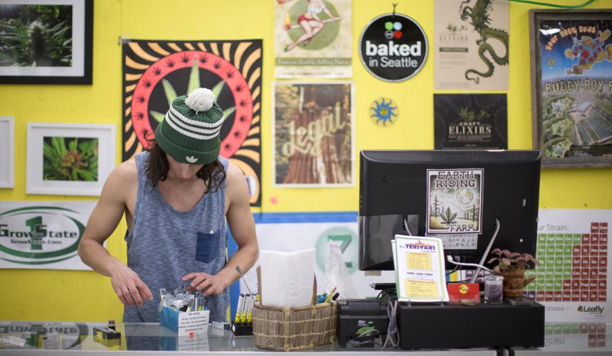 In this March 14, 2016 photo, Sky Stover, 22, works behind the counter at Margie's Pot Shop in Bingen, Wash. Recreational marijuana sales have declined at the store near the Washington state-Oregon border, since recreational marijuana began selling Oregon. (Beth Nakamura/The Oregonian via AP) MAGS OUT; TV OUT; NO LOCAL INTERNET; THE MERCURY OUT; WILLAMETTE WEEK OUT; PAMPLIN MEDIA GROUP OUT; MANDATORY CREDIT