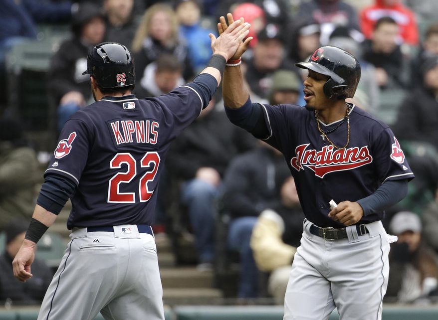 Cleveland Indians' Francisco Lindor, right, celebrates with Jason Kipnis after scoring on a fielder's choice by Carlos Santana during the first inning of a baseball game against the Chicago White Sox, Friday, April 8, 2016, in Chicago. (AP Photo/Nam Y. Huh)