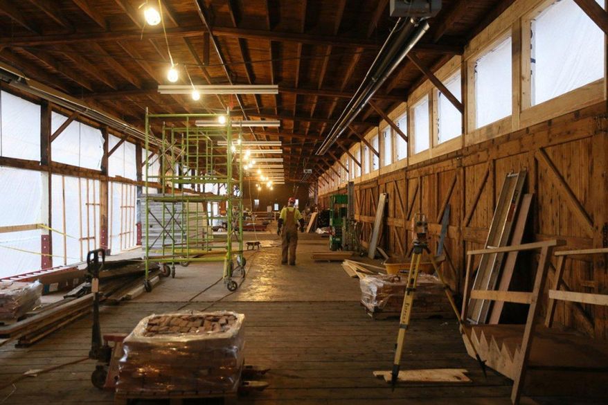 In this March 31, 2016 photo, a worker stands inside an under construction space in the historic Depot Building which will become HopCat, a popular craft beer bar based in Grand Rapids, Mich., that is expanding across the Midwest, and is coming to downtown Kalamazoo. The state of Michigan is backing a renovation of the historic Depot Building in downtown Kalamazoo with more than $480,000 in funding. (Mark Bugnaski/Kalamazoo Gazette-MLive Media Group via AP) LOCAL TELEVISION OUT; LOCAL RADIO OUT; MANDATORY CREDIT