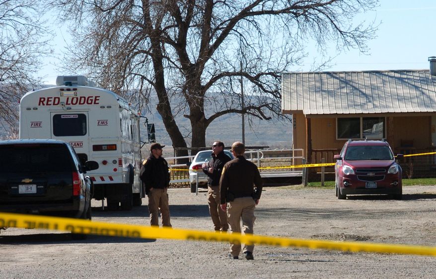 Law enforcement is seen at the scene of a triple slaying in the small town of Belfry, Mont. on Friday, April 8, 2016. A man accused of killing three people he was living with in a tiny Montana town was arrested early Friday after authorities tracked him to Washington state. Robert James LeCou faces three counts of deliberate homicide in the shooting deaths of two women and one man, whose bodies were discovered in a home in the tight-knit town of Belfry. (AP Photo/Matthew Brown)