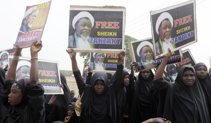 FILE- In this Friday April 1, 2016 file photo, Nigerian Shiite Muslims take to the street to protest and demanded the release of Shiite leader Ibraheem Zakzaky in Cikatsere, Nigeria. A human rights lawyer says the detained leader of Nigeria’s Shiite Muslims has been left near-blind and suffered several operations to remove bullets from gunshots in an army raid on his home (AP Photo/Sunday Alamba file)