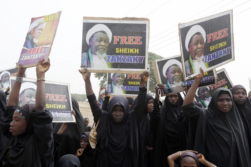 FILE- In this Friday April 1, 2016 file photo, Nigerian Shiite Muslims take to the street to protest and demanded the release of Shiite leader Ibraheem Zakzaky in Cikatsere, Nigeria. A human rights lawyer says the detained leader of Nigeria’s Shiite Muslims has been left near-blind and suffered several operations to remove bullets from gunshots in an army raid on his home (AP Photo/Sunday Alamba file)