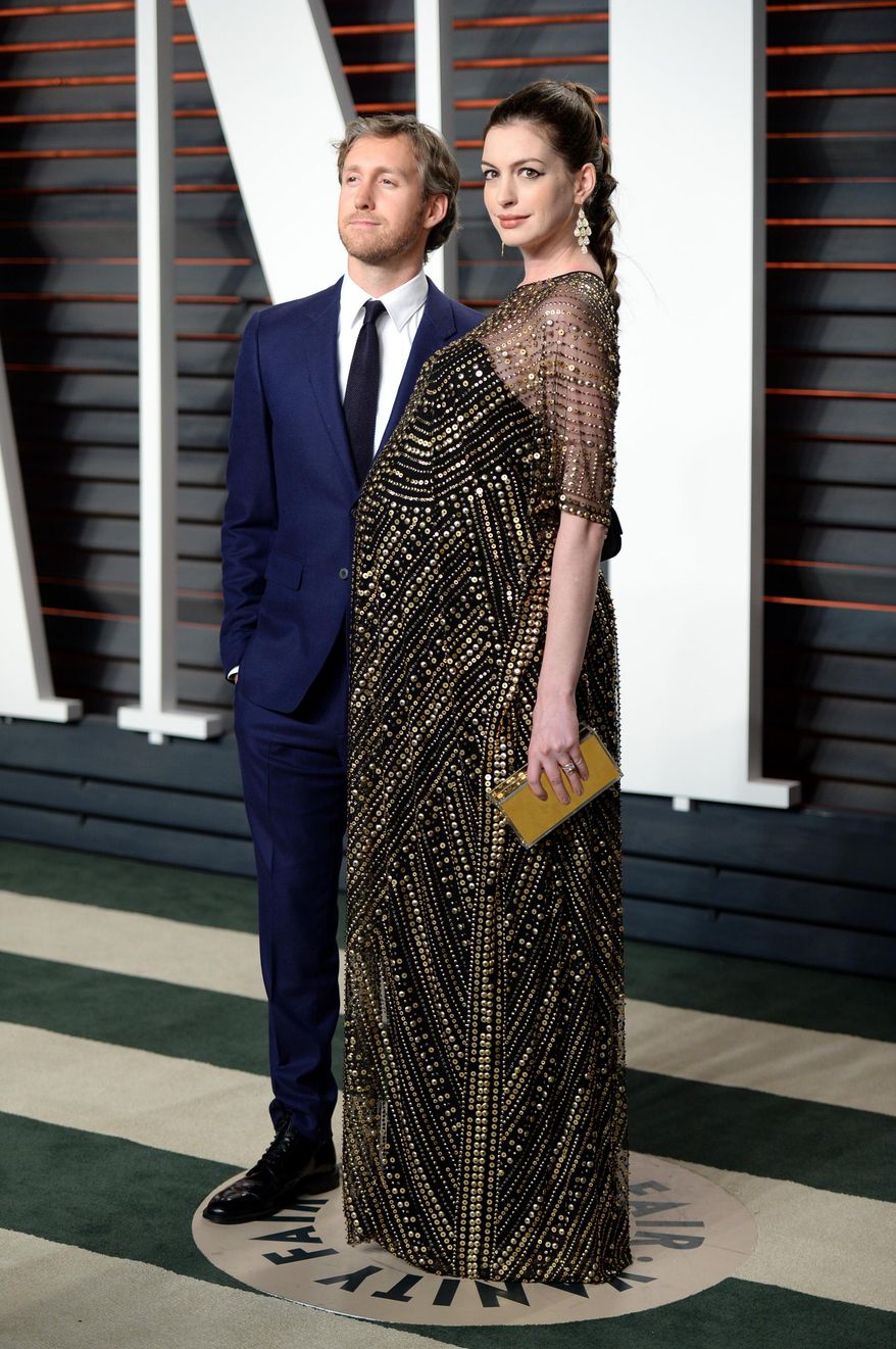 FILE- In this Feb. 28, 2016, file photo, Adam Shulman, left, and Anne Hathaway arrive at the Vanity Fair Oscar Party in Beverly Hills, Calif. E! reported Thursday, April 7, that the Oscar-winning star of "Les Miserables" and husband Adam Shulman welcomed a son named Jonathan Rosebanks Shulman on March 24. (Photo by Evan Agostini/Invision/AP, File)