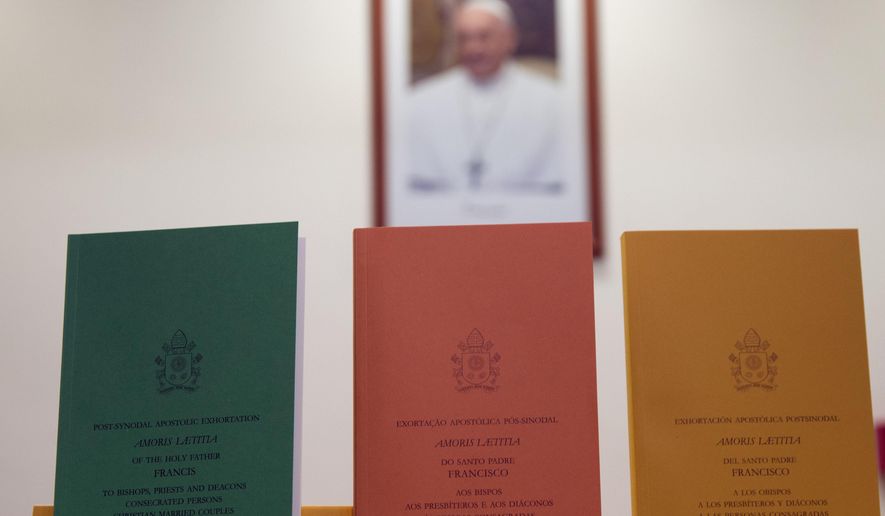 Copies of the post-synodal apostolic exhortation ' Amoris Laetitia ' (The Joy of Love) document are on display prior to the start of a press conference, at the Vatican, Friday, April 8, 2016. Pope Francis has insisted that individual conscience be the guiding principle for Catholics negotiating the complexities of sex, marriage and family life in a major document released Friday that repudiates the centrality of black and white rules for the faithful. In the 256-page document "The Joy of Love," released Friday, Francis makes no change in church doctrine. (AP Photo/Andrew Medichini)