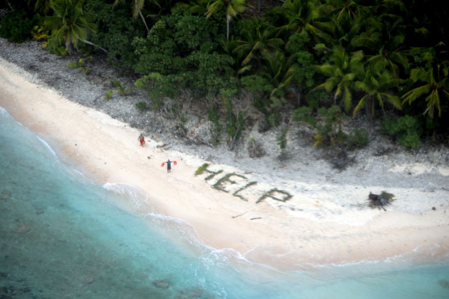 This photo provided by U.S. Navy released April 7, 2016 shows two men waving life jackets and look on as a U.S. Navy P-8A maritime surveillance aircraft discovers them on the uninhabited island of Fanadik. The three men were back to safety on Thursday, April 7, 2016, three days after going missing. (U.S. Navy/Ensign John Knight via AP)