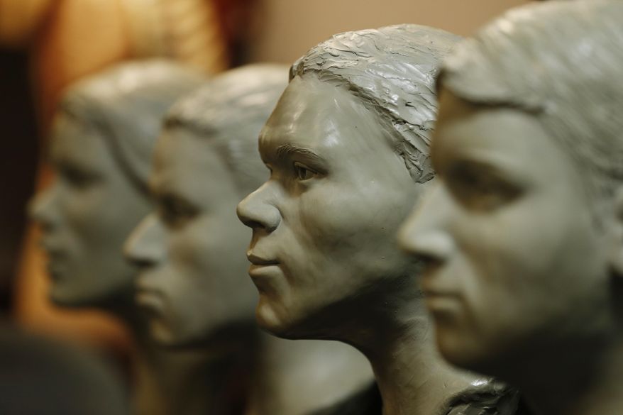 Busts of unidentified crime victims are lined up in the offices of the Chief Medical Examiner for Virginia Tuesday, March 15, 2016, in Richmond, Va. The medical examiner's office is hoping a new set of facial sculptures created by the FBI will help identify eight people found dead in Virginia between 1972 and 2014. (AP Photo/Steve Helber)