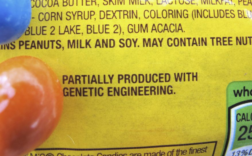 In this April 8, 2016 photo, a new disclosure statement is displayed on a package of Peanut M&M�s candy in Montpelier, Vt., saying they are "Partially produced with genetic engineering." Vermont is set to become the first state in the country on July 1 to require the labeling of foods made with genetically modified ingredients. (AP Photo/Lisa Rathke)