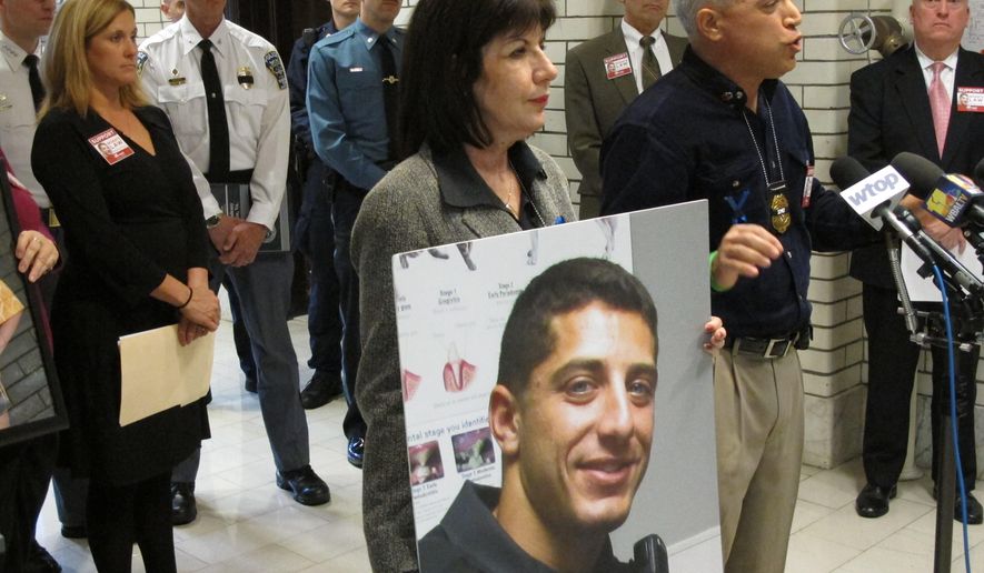 Rich Leotta, the father of police officer Noah Leotta who died after being hit by a suspected drunk driver while on duty last year, urges Maryland lawmakers on Saturday, April 9, 2016 in Annapolis, Md., to pass the strongest of two bills requiring ignition interlock devices for drunk drivers who blow a .08 in a breath test. His wife, Marcia Goldman, is holding a picture of Noah. Maryland’s legislative session ends Monday at midnight, and differences in legislation on a variety of issues passed by the House and Senate are still being reconciled. (AP Photo/Brian Witte)