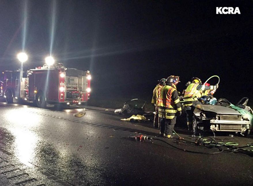 In this April 9, 2016 photo provided by KCRA-TV, firefighters view the wreckage of a Honda Civic that slammed into a Chevrolet Silverado pickup truck, killing all five occupants, on a two-lane highway in Rio Vista, Calif., about 40 miles southwest of Sacramento. (Tom Miller/KCRA-TV via AP) MANDATORY CREDIT; TV OUT