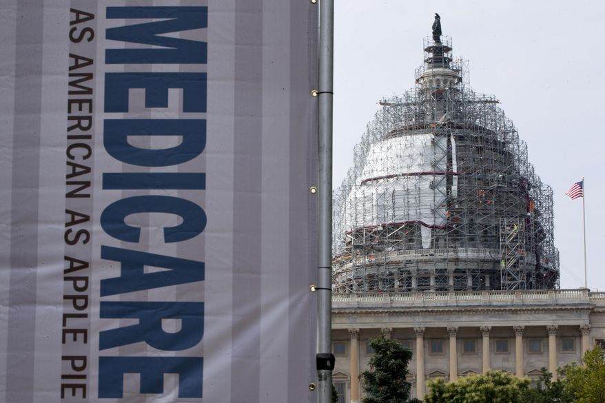 FILE - In this July 30, 2015 file photo, a sign supporting Medicare is seen on Capitol Hill in Washington. A Medicare proposal to test new ways of paying for chemotherapy and other drugs given in a doctor's office has sparked a furious battle, and cancer doctors are demanding that the Obama administration scrap the experiment. (AP Photo/Jacquelyn Martin, File)