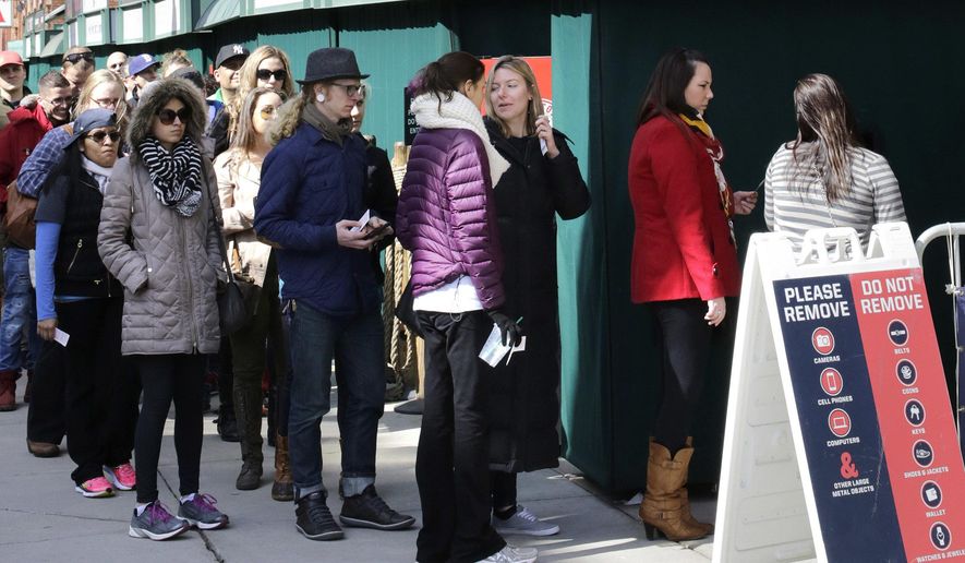 People form a line outside Fenway Park while waiting for a guided tour of the baseball park, Sunday, April 10, 2016, in Boston. The Red Sox are to play the Baltimore Orioles, Monday at Fenway in their home-opener. (AP Photo/Steven Senne)