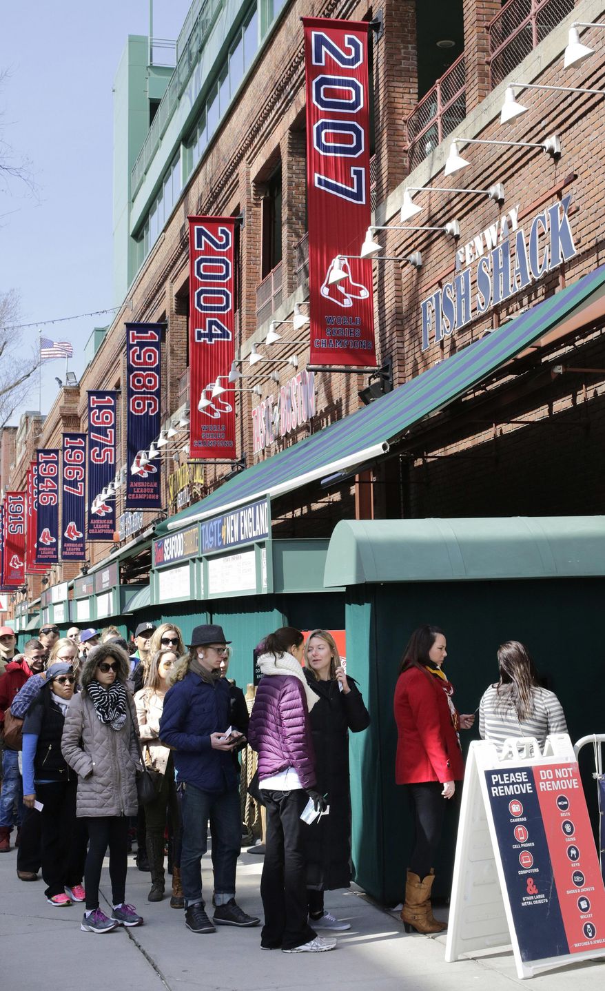 People form a line outside Fenway Park while waiting for a guided tour of the baseball park, Sunday, April 10, 2016, in Boston. The Red Sox are to play the Baltimore Orioles, Monday at Fenway in their home-opener. (AP Photo/Steven Senne)