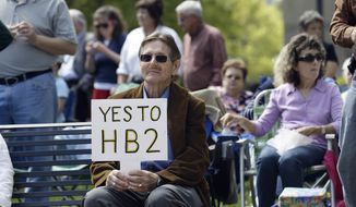 Supporters of House Bill 2 gather at the North Carolina State Capitol in Raleigh, N.C., Monday, April 11, 2016, during a rally in support of a law that blocks rules allowing transgender people to use the bathroom aligned with their gender identity. (AP Photo/Gerry Broome)