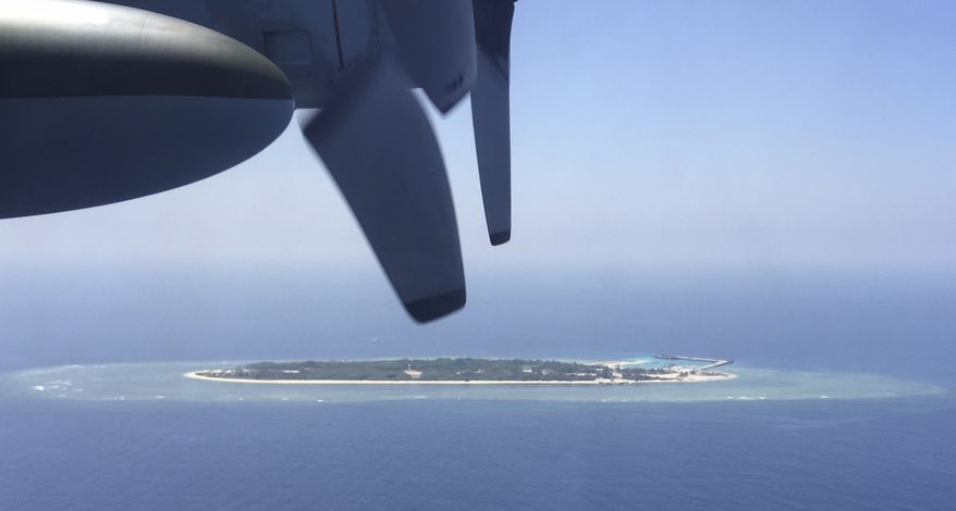 FILE - In this March 23, 2016, file photo, an aerial view is seen from a military plane carrying international journalists of the Taiwan-controlled Taiping island, also known as Itu Aba, in the Spratly archipelago, roughly 1600 kms. (1000 miles) in the South China Sea of southern Taiwan. Tensions in the South China Sea are rising, pitting China against smaller and weaker neighbors who all lay claim to a string of isles, coral reefs and lagoons, rich in fish and potential gas and oil reserves. (AP Photo/Johnson Lai, File)