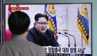 A man watches a TV news program showing file footage of North Korean leader Kim Jong-un at Seoul Railway Station in Seoul, South Korea, Monday, April 11, 2016. A colonel from North Korea&#x27;s military spy agency fled to South Korea last year in a rare senior-level defection, Seoul officials said Monday. The letters read &quot;True, A colonel from North Korean military&#x27;s General Reconnaissance Bureau Asylum.&quot; (AP Photo/Lee Jin-man)