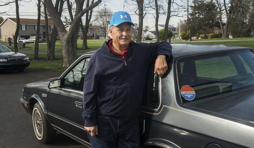 In an April 6, 2016 photo, Gettysburg, Pa. resident Mike Lawn stands next to a car formerly owned by Hillary Clinton in Gettysburg, Pa. The retired White House gardener is selling Clinton’s 1986 Oldsmobile Cutlass, which he bought at an auction for the residence’s workers and has been sitting in his Pennsylvania garage for years. (Clare Becker/The (Hanover, Pa.) Evening Sun via AP)