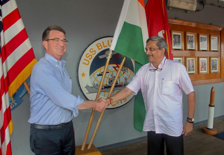 Indian Defence Minister Manohar Parrikar, right, greets US Defense Secretary Ashton Carter during his visit to the Indian Naval Base in Karwar, Karnataka state, India, Monday, April 11, 2016.(Press Trust of India via AP)INDIA OUT