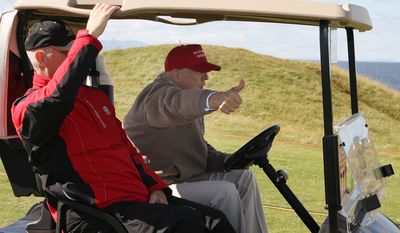 U.S. Presidential contender Donald Trump, right, gestures to the media as he drives a buggy on the first day of the Women&#x27;s British Open golf championship at the Turnberry golf course in Turnberry, Scotland, Thursday, July 30, 2015. Trump turned a brief trip to a golf tournament in Scotland into an extension of his presidential campaign trail when he attended the Women&#x27;s British Open at his plush Turnberry resort on Thursday. (AP Photo/Scott Heppell)