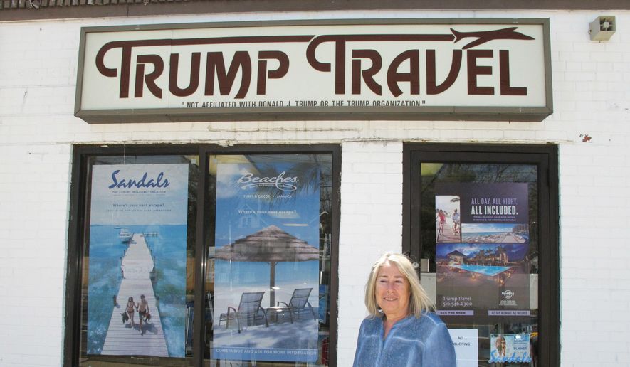 In this April 6, 2015, file photo, Claudia Rabin-Manning stands outside her Baldwin, N.Y., business, Trump Travel. Rabin-Manning says she has been the target of legal action from Republican presidential candidate Donald Trump over the use of the name Trump Travel. She explains the business name has nothing to do with the businessman, and instead was named by a previous owner of the travel agency who played canasta, where the "trump card" is used in the game. (AP Photo/Frank Eltman)