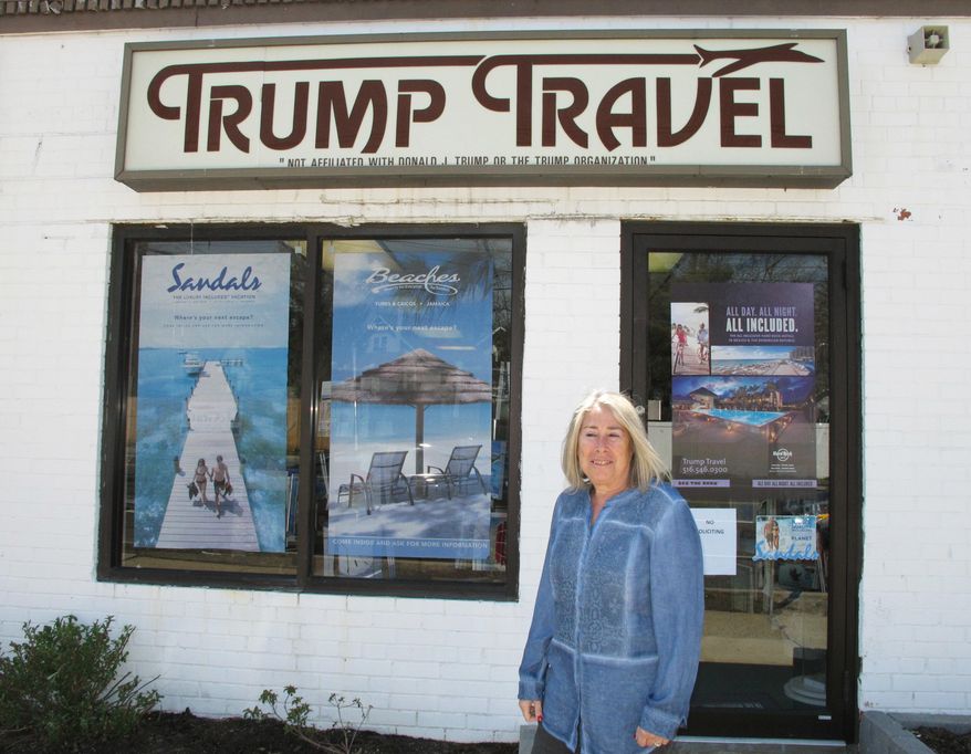 In this April 6, 2015, file photo, Claudia Rabin-Manning stands outside her Baldwin, N.Y., business, Trump Travel. Rabin-Manning says she has been the target of legal action from Republican presidential candidate Donald Trump over the use of the name Trump Travel. She explains the business name has nothing to do with the businessman, and instead was named by a previous owner of the travel agency who played canasta, where the "trump card" is used in the game. (AP Photo/Frank Eltman)