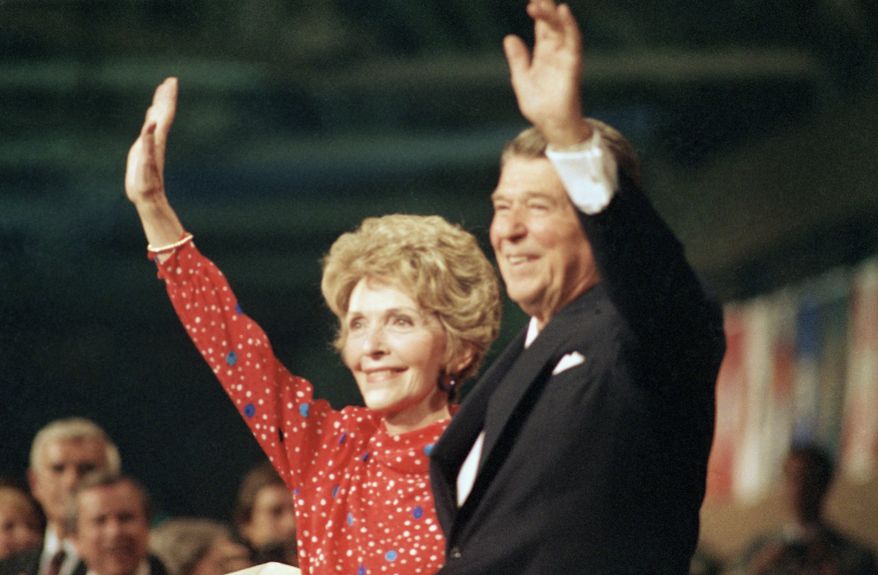 U.S. President Ronald Reagan with wife first lady  Nancy Reagan, address crowd at the Republican National Convention in Dallas, Texas, on Aug. 24, 1984. Reagan was seeking his second term as U.S. President. (AP Photo)