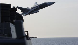 In this image released by the U.S. Navy, a Russian SU-24 jet makes a close-range and low altitude pass near the USS Donald Cook on Tuesday, April 12, 2016, in the Baltic Sea. The Russian attack planes buzzed the U.S. Navy destroyer multiple times on Monday and Tuesday, at one point coming so close, an estimated 30 feet, that they created wakes in the water around the ship, a U.S. official said Wednesday, April 13. (U.S. Navy via AP)