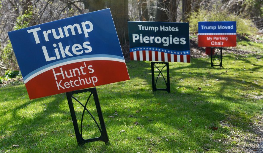 In this April 12, 2016 photo, humorous anti-Donald Trump campaign signs are displayed on Dr. Eric Rickin's yard, in Fox Chapel, Pa. Rickin decided to speak out against Trump's Pittsburgh campaign stop with some Pittsburgh-style digs, including Heinz ketchup and using chairs to save on-street parking spaces. (Michael Henninger /Pittsburgh Post-Gazette via AP) MAGS OUT; MONESSEN OUT; KITTANNING OUT; CONNELLSVILLE OUT; GREENSBURG OUT; TARENTUM OUT; NORTH HILLS NEWS RECORD OUT; BUTLER OUT; MANDATORY CREDIT