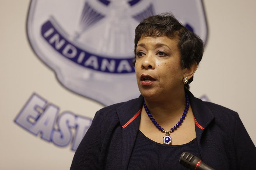 Attorney General Loretta E. Lynch talks with police officers in Indianapolis as part of her national Community Policing Tour, Wednesday, April 13, 2016. (AP Photo/Michael Conroy)
