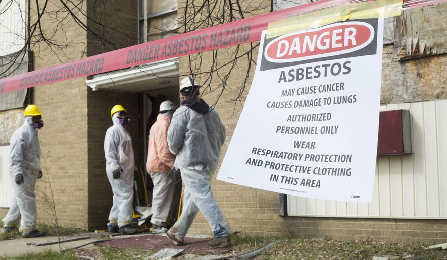 The city of Flint and Genesee County Land Bank begin the abatement and demolition of the former Glen Acres Apartments in Flint, Mich., Wednesday, April 13, 2016. The $1.7 million in work is funded by the Department of Housing and Urban Development's Community Development Block Grant monies from the City of Flint and allows the Genesee County Land Bank to address immediate safety and contamination concerns on the site. (Conor Ralph/The Flint Journal- MLive.com via AP)