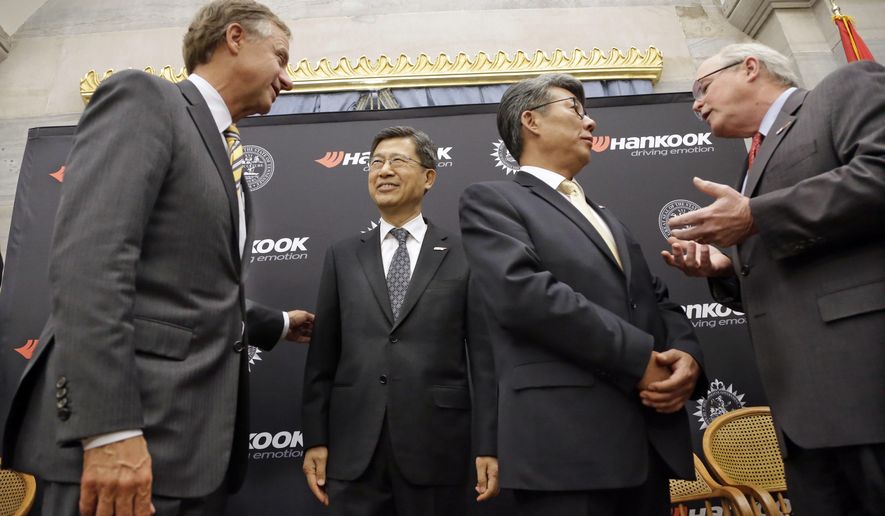 Tennessee Gov. Bill Haslam, left, talks with S. H. John Sun, vice chairman and CEO of Hankook Tire Wednesday, April 13, 2016, in Nashville, Tenn., after it was announced that Hankook is relocating its North American headquarters from New Jersey to Tennessee. Ralph Schulz, right, president of the Nashville Chamber of Commerce, talks with Hee Se Ahn, president of Hankook Tire America Corp. (AP Photo/Mark Humphrey)