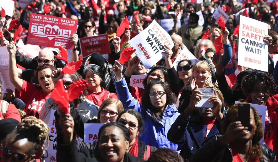 Nurses from around the state rally outside the state Capitol, Wednesday, April 13, 2016, in Albany, N.Y. Nearly 2,000 nurses are urging lawmakers to pass a minimum staffing law that would mandate how many nurses are on duty at hospitals and nursing homes.(AP Photo/Mike Groll)