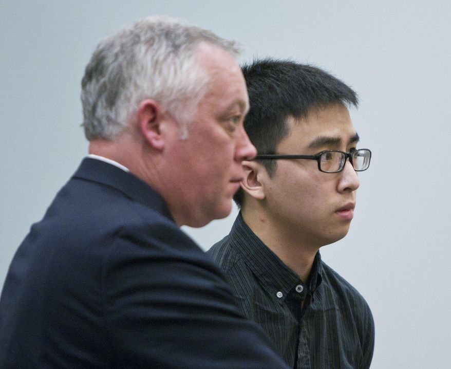 Joseph Hoai Nguyen, right, appears for his sentencing with defense attorney, Brett Stevenson, at the Kent County Courthouse in downtown Grand Rapids, Mich., Wednesday, April 13, 2016. Joseph Nguyen pleaded guilty to involuntary manslaughter in the death of his 5-month-old nephew, Isaiah Nguyen. (Cory Morse/The Grand Rapids Press via AP) ALL LOCAL TELEVISION OUT; LOCAL TELEVISION INTERNET OUT; MANDATORY CREDIT