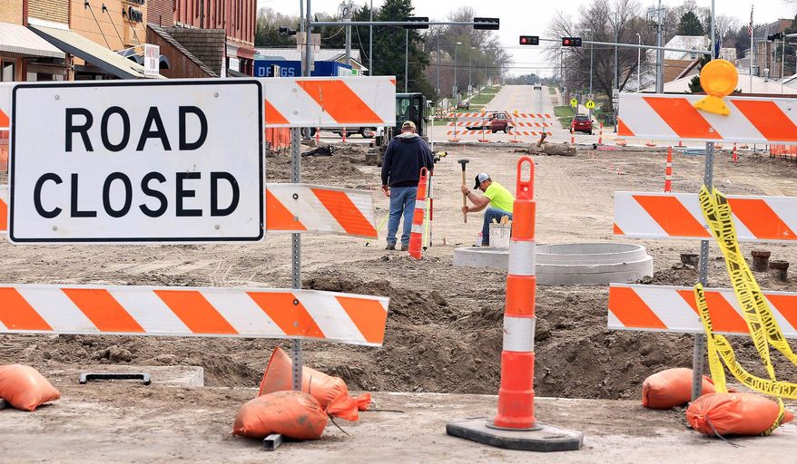 In this April 5, 2016 photo, Myers Construction employees work in Broken Bow, Neb. The street is part of a large downtown improvements project underway in Broken Bow. (Barrett Stinson/The Independent via AP) MANDATORY CREDIT
