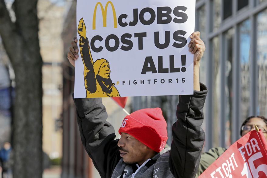 Solo Littlejohn, a fast food worker from Cicero, Ill., joins protesters calling for a union and pay of $15 an hour outside a McDonald's restaurant in Chicago on Thursday, April 14, 2016. The "Fight for $15" is part of an ongoing push targeting the world's biggest hamburger chain. (AP Photo/Teresa Crawford)